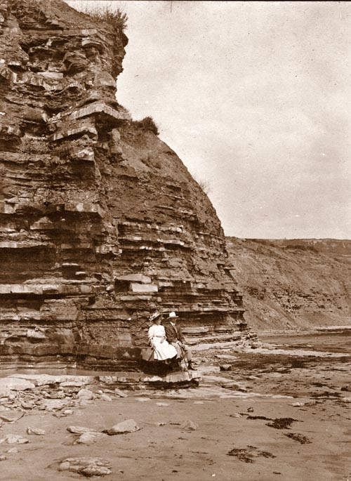 This is a picture from 1909 of a couple sitting on the Blue Lias Rocks on the East Beach at Lyme Regis.  This image is from The Freshford - Charmouth collection.
