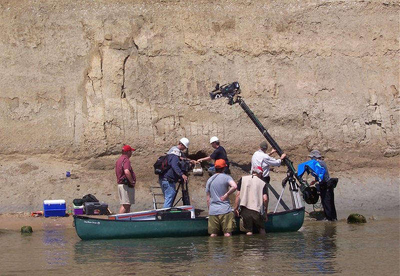 A Film Crew at the Calvert Cliffs filming a dolphin skull excavation.